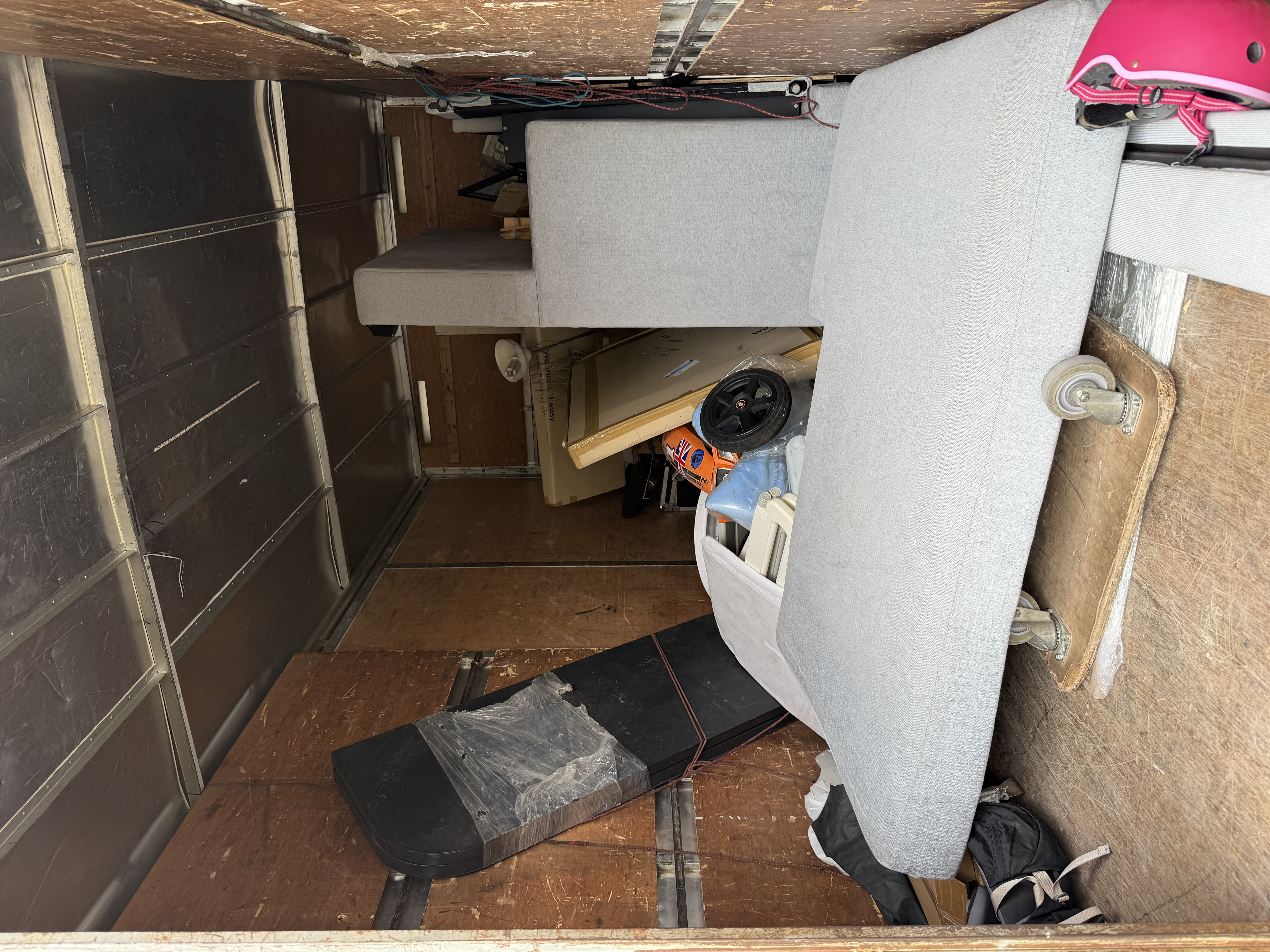 Items from the Holland pickup secured inside the truck — sofa, mattress base, and assorted smaller pieces ready for transport.